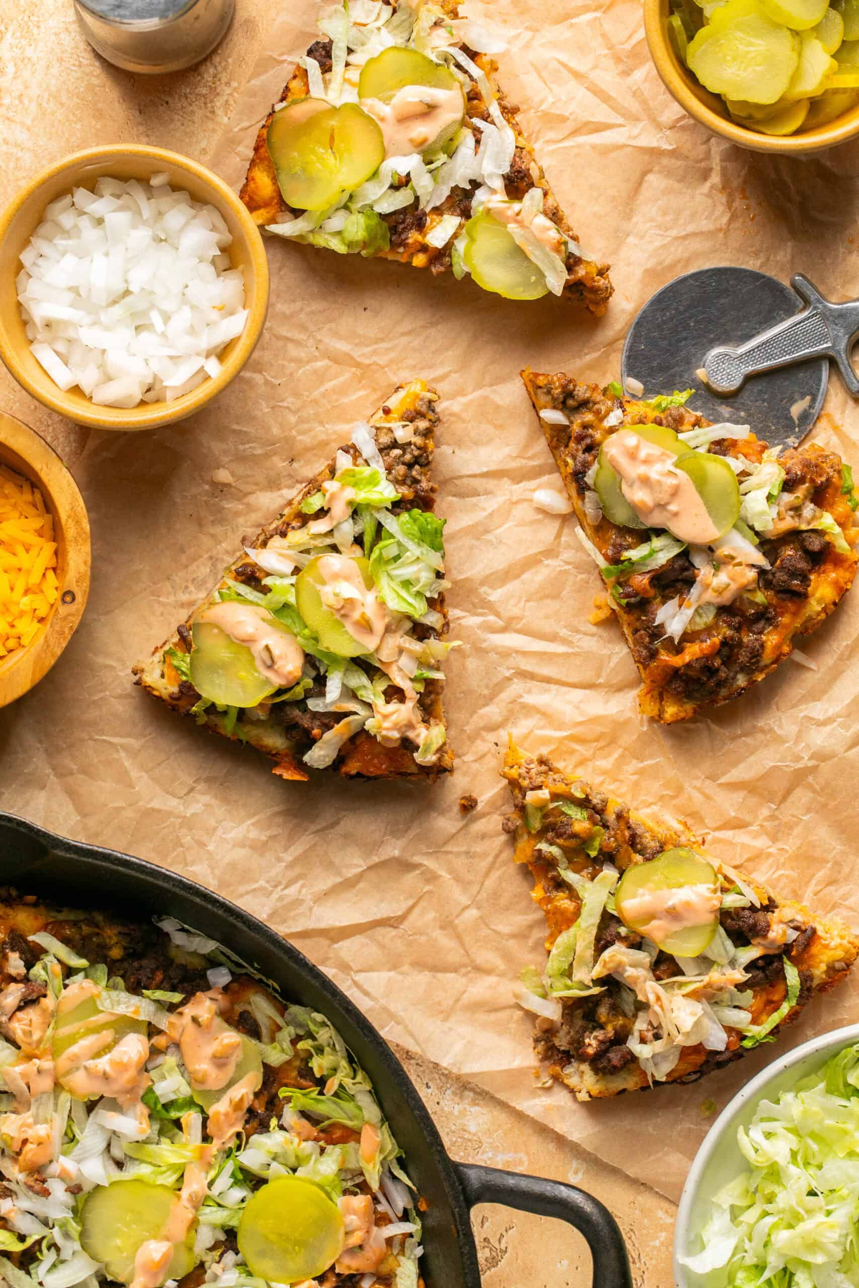 Slices of pizza laid out with toppings in small bowls around.