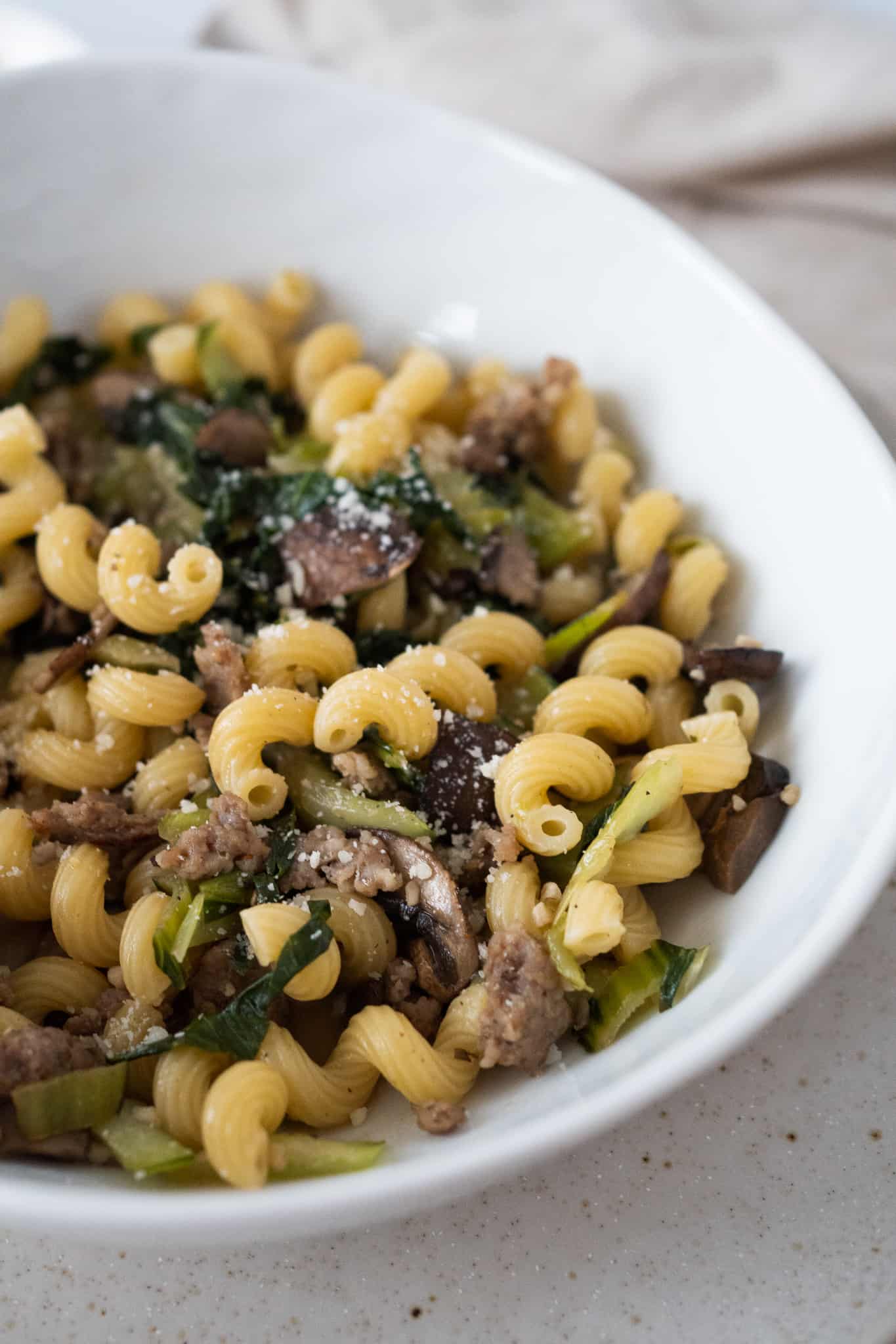 Bowl of sausage and bok choy pasta.