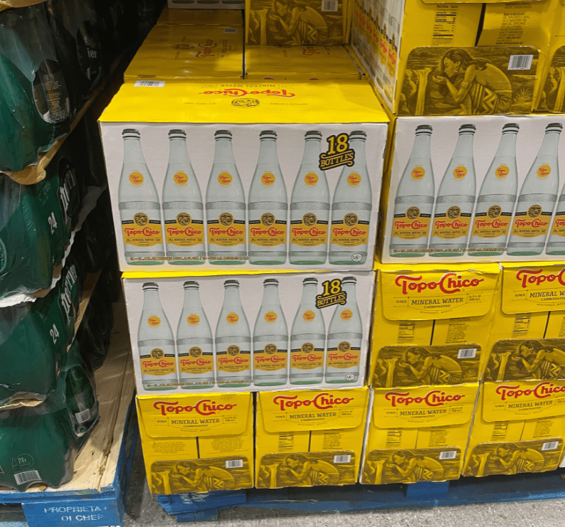 Boxes with bottles of Topo Chico mineral water.