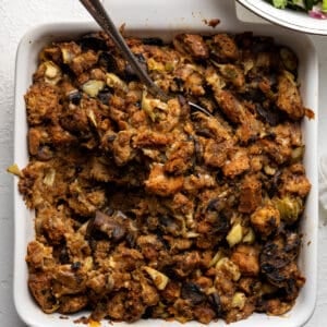 Spoon in a baking dish of holiday stuffing.