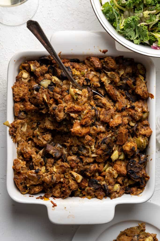 Spoon in a baking dish of holiday stuffing.