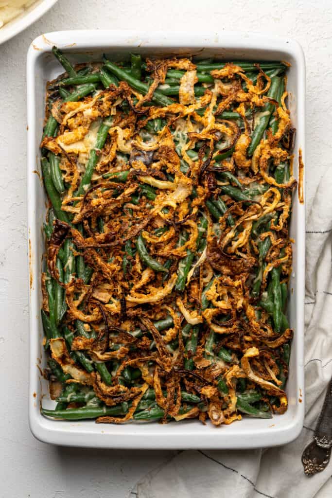 Green beans with cheese and fried onions on top.