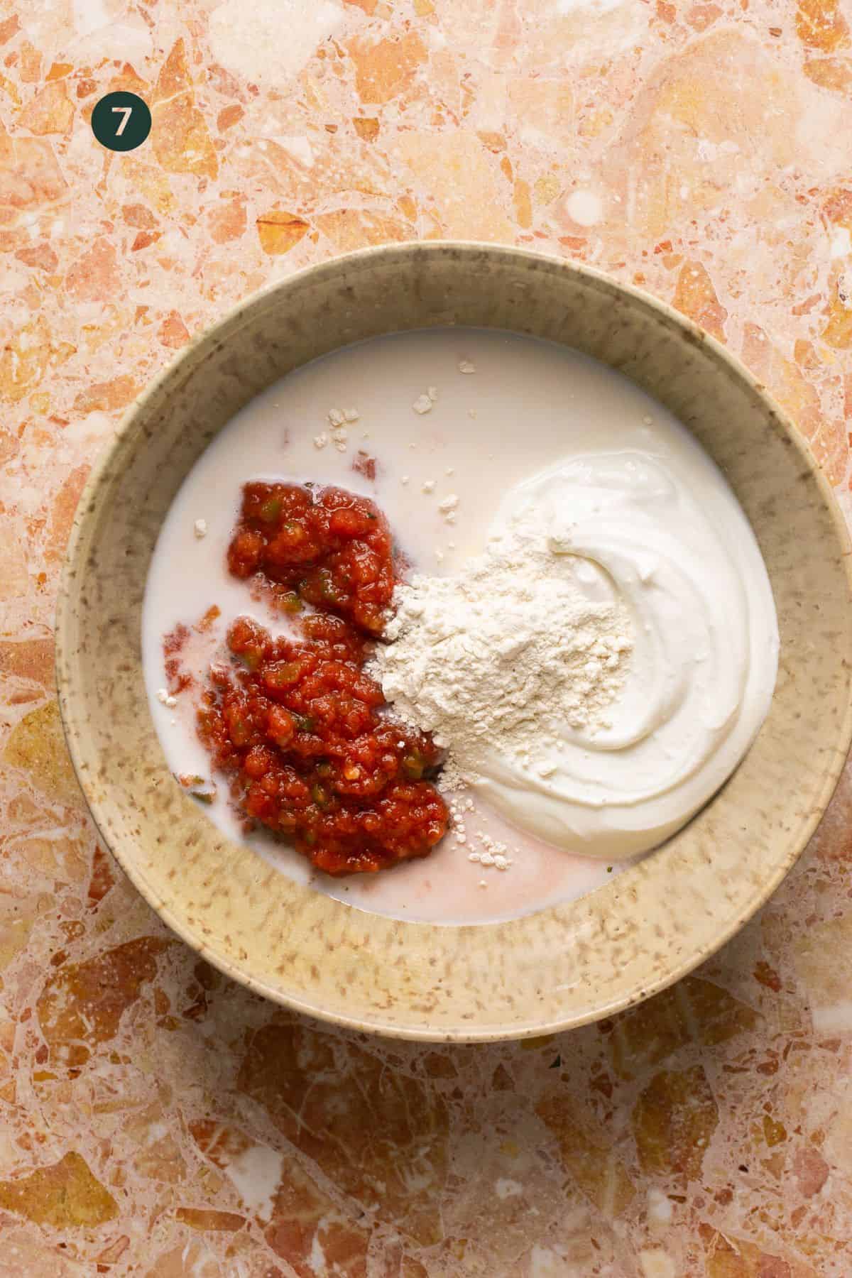Cottage cheese, flour, salsa and flour added to a small bowl to mix. 
