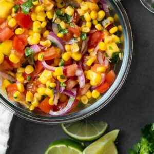 Glass bowl of mango corn salsa.