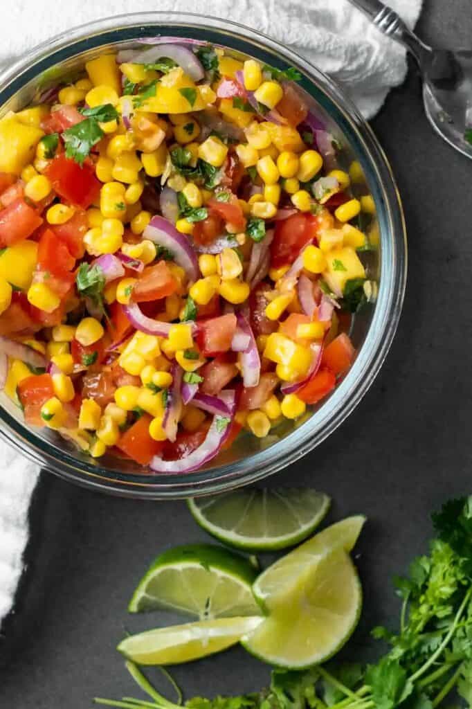 Glass bowl of mango corn salsa.