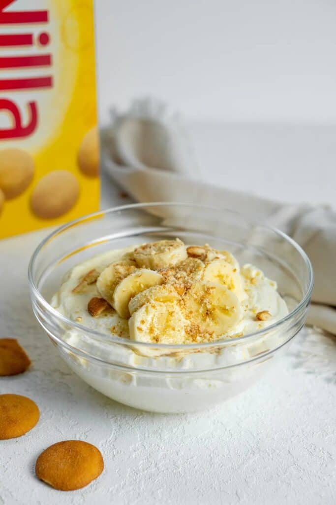 Glass bowl of banana pudding dip with a box of Nilla wafers.