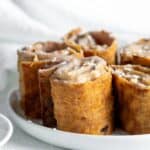 Plate of cinnamon cream cheese roll ups.