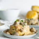 Small plate of turkey gravy and biscuits.