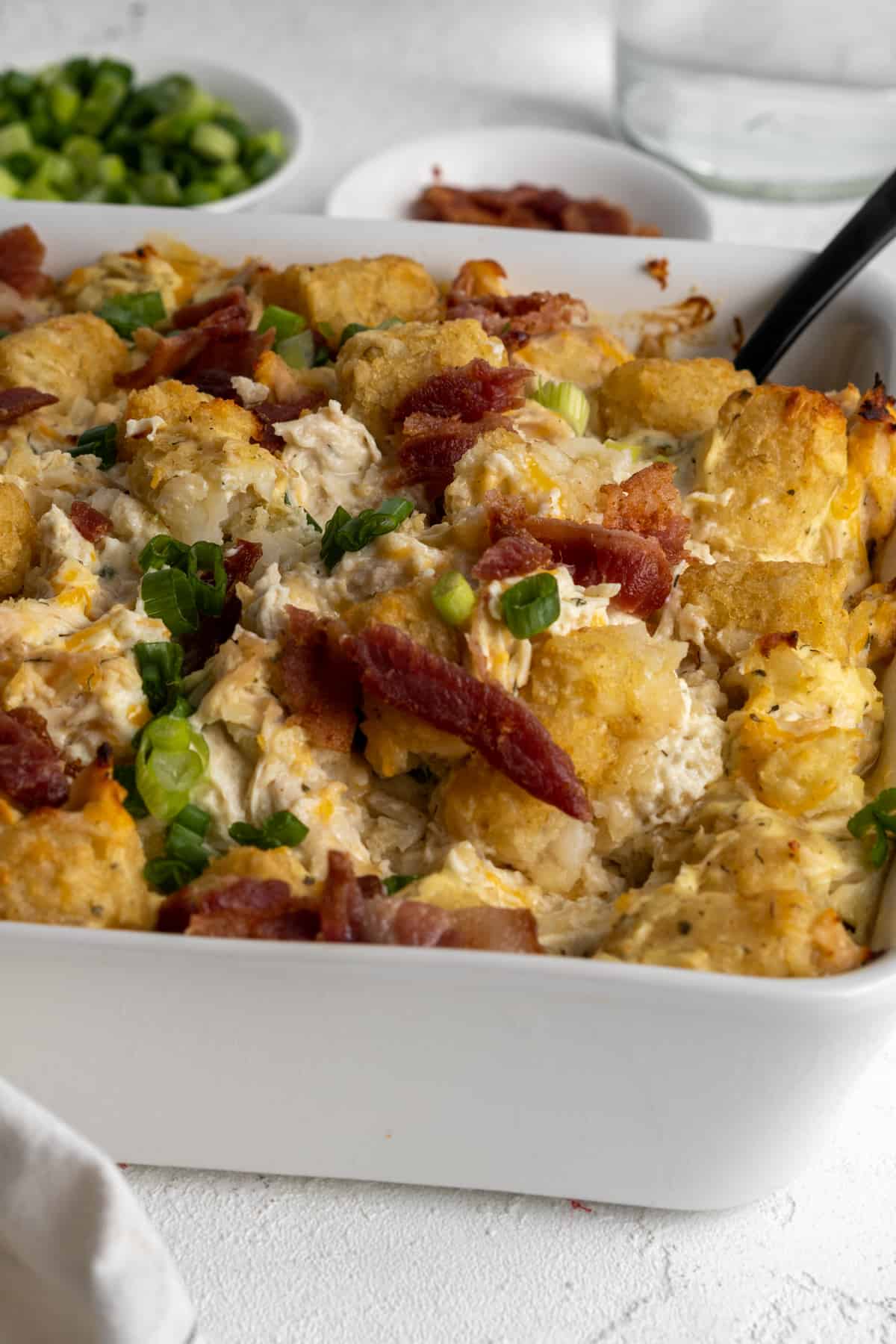 Chicken casserole topped with tater tots and turkey bacon. 