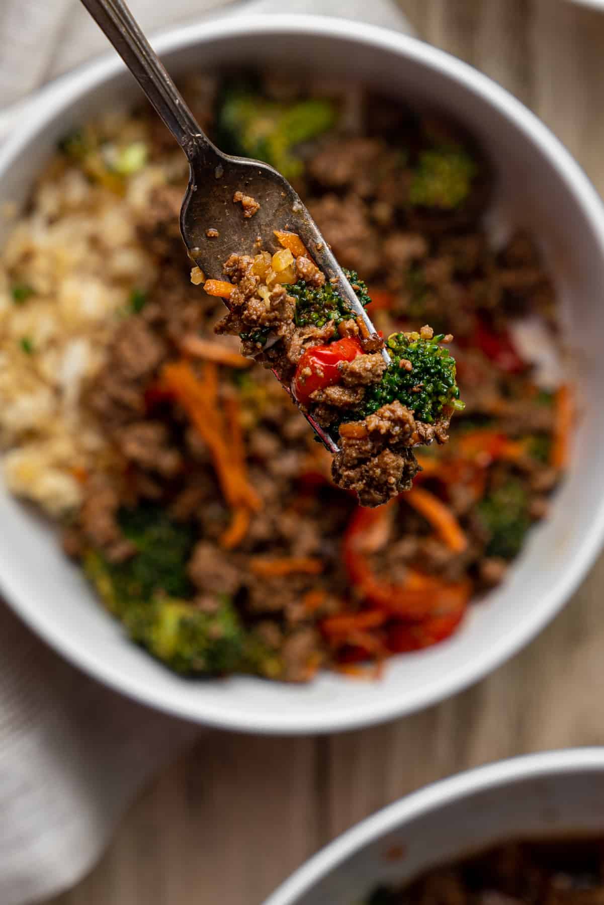 Fork with some teriyaki beef and vegetables.