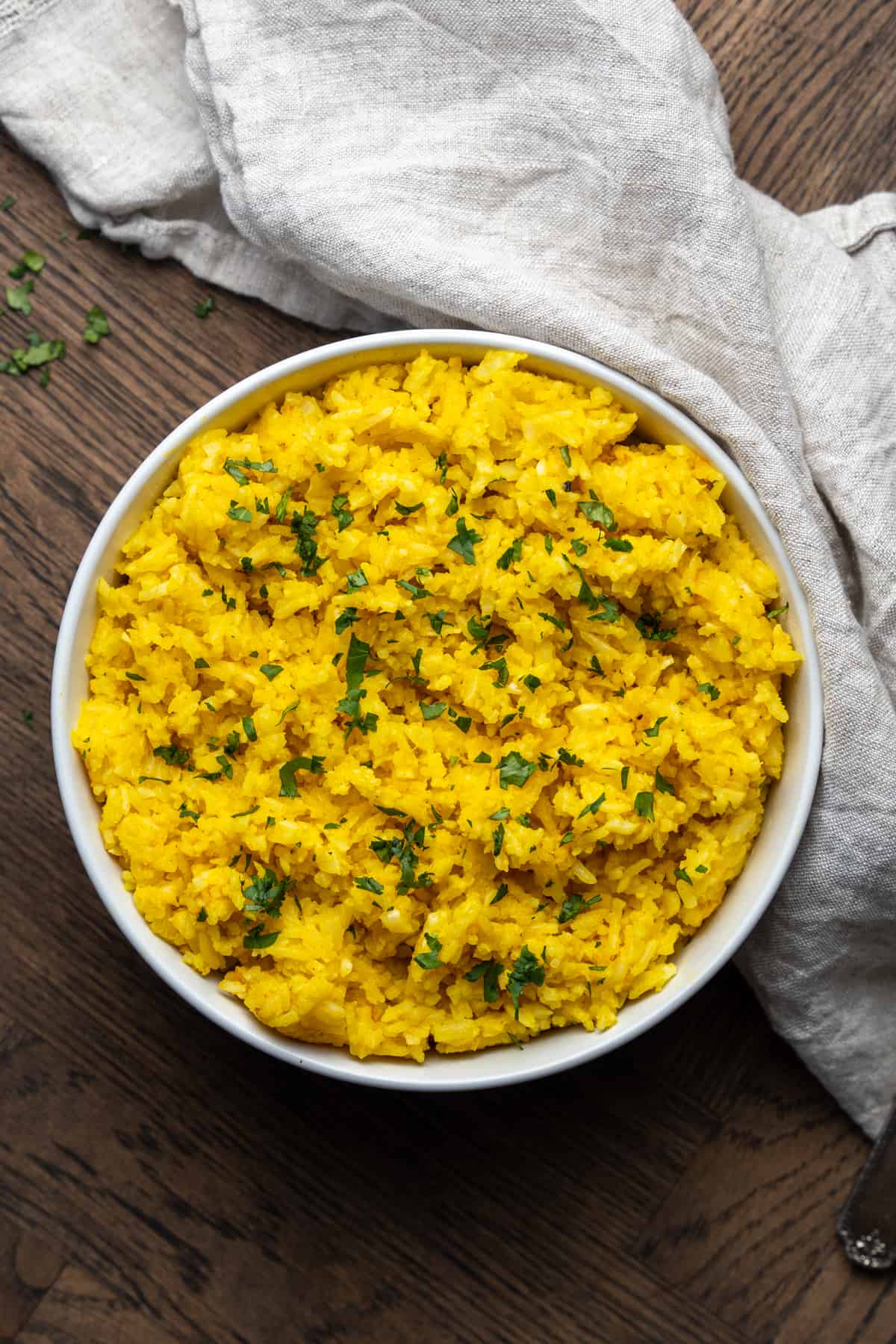 White bowl of garlic turmeric rice.