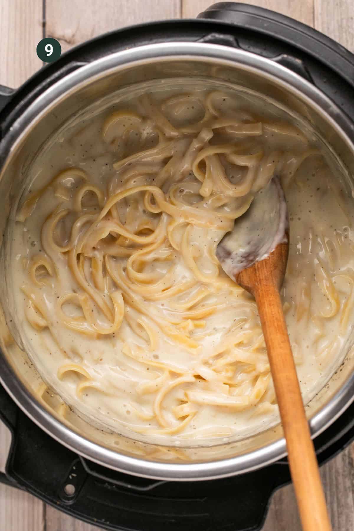 Fully combined and creamy fettuccine alfredo in the base of the instant pot.