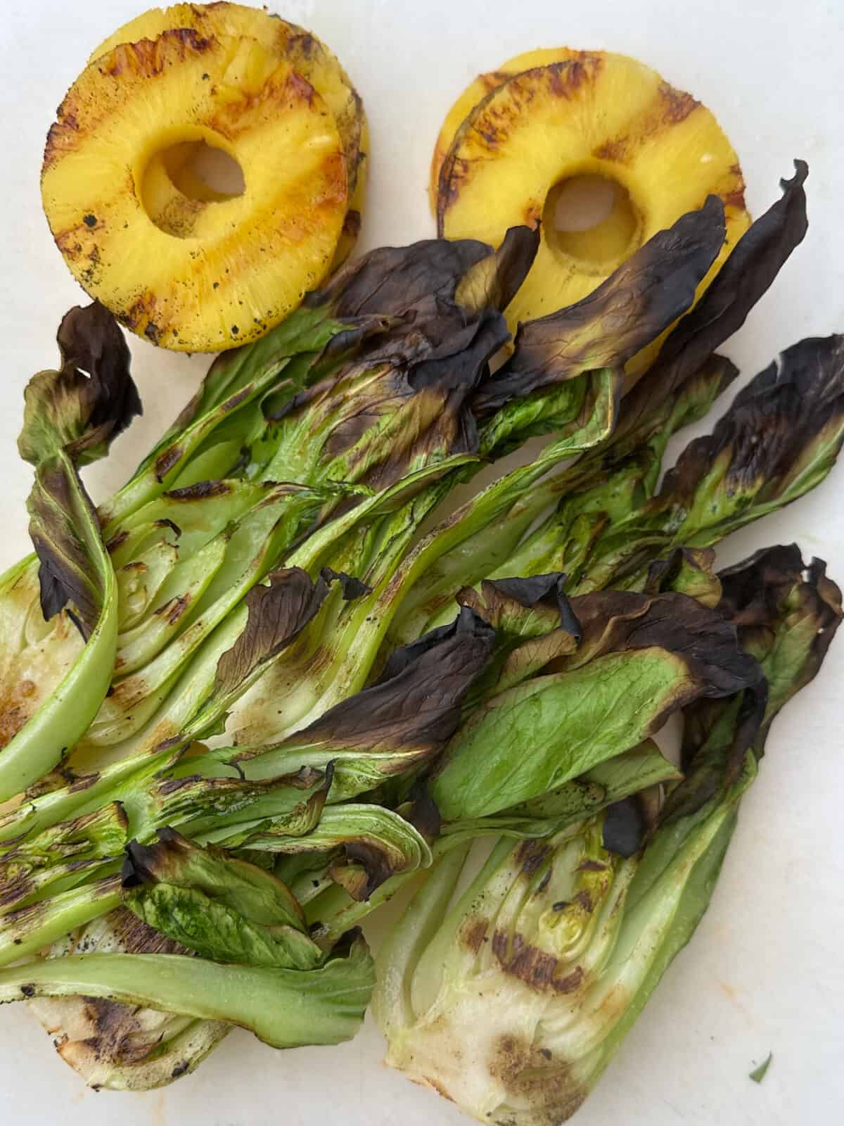 Grilled baby bok choy and pineapple slices.