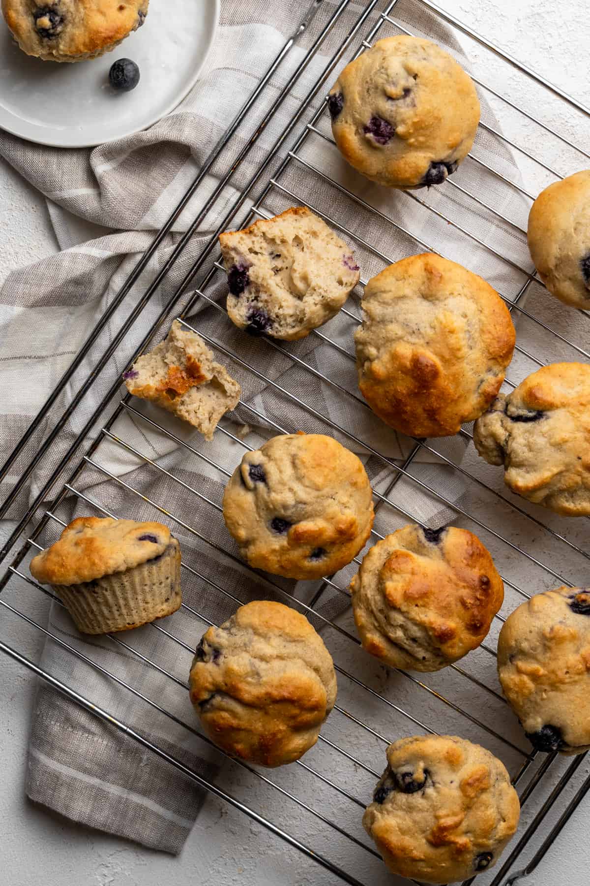 Blueberry protein muffins on a wire rack.