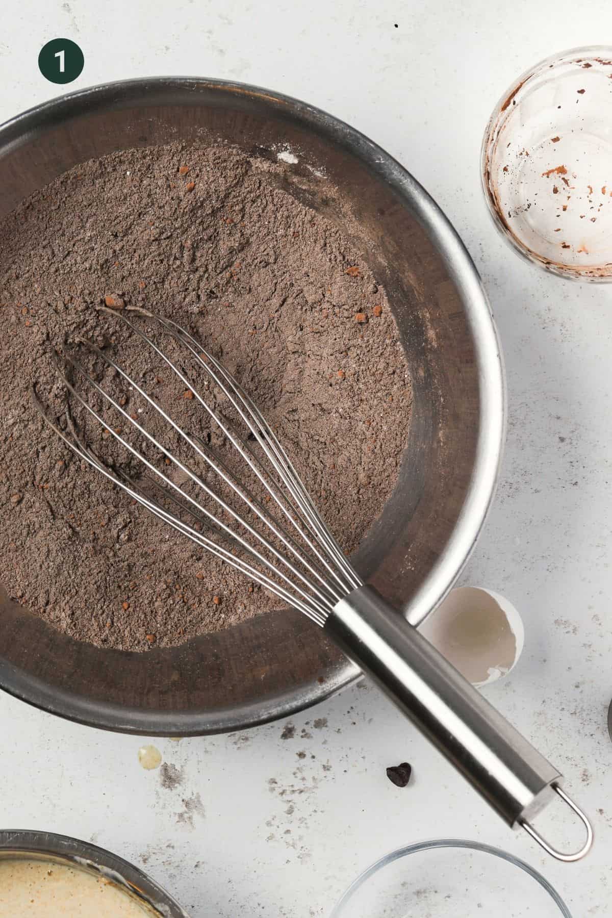 Cocoa powder, sugar, flour, baking soda and powder and salt combined in a mixing bowl.