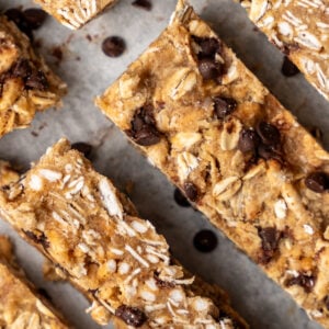 Chewy chocolate protein granola bars on parchment paper.