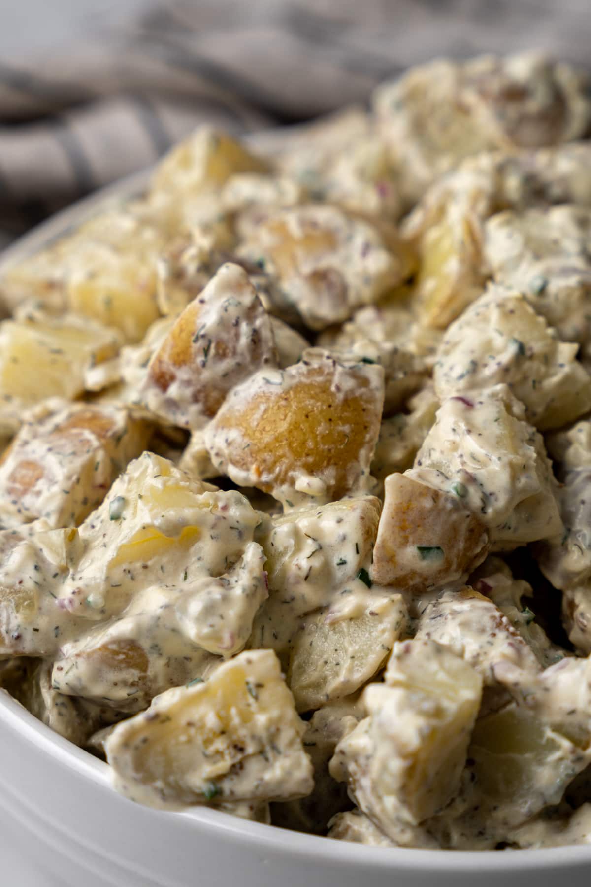 Potato salad piled high in a bowl.