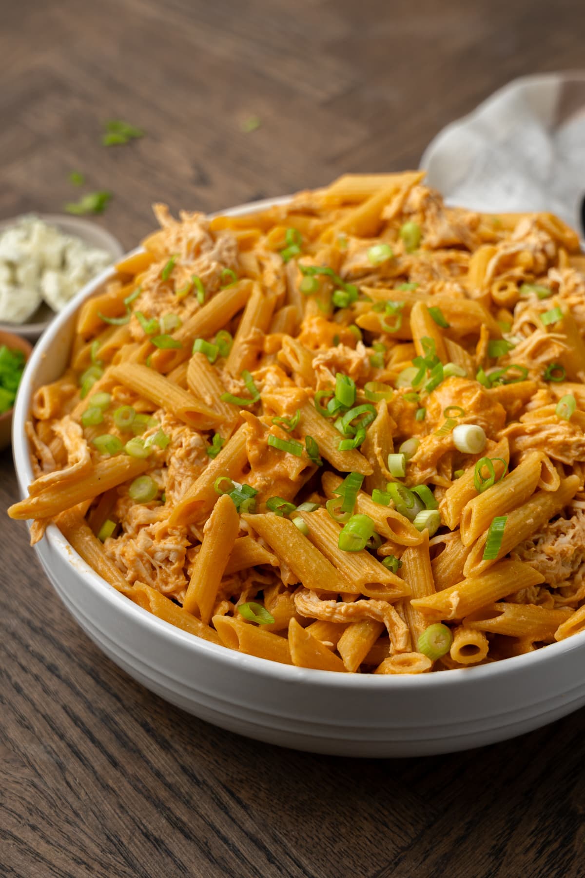 Buffalo chicken pasta topped with thinly sliced green onions.