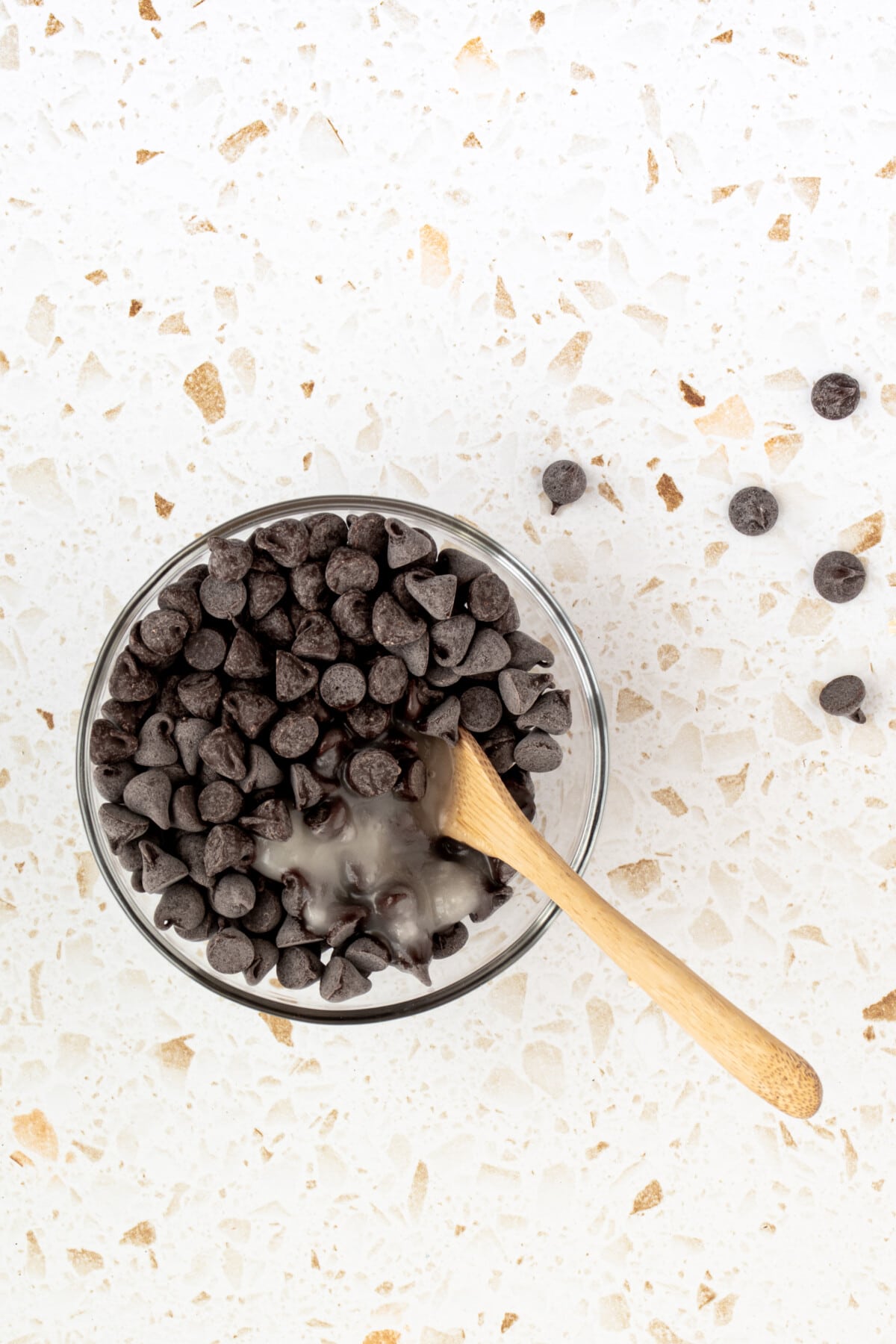 Spoon in a bowl of chocolate chips.