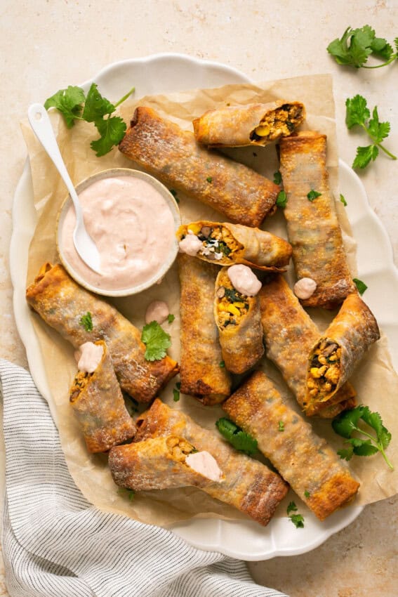 Air fryer southwest egg rolls on a parchment-lined platter.