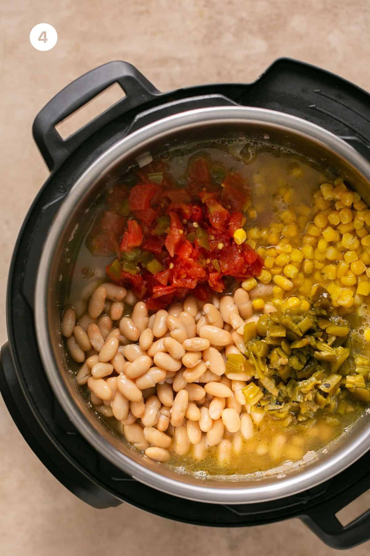 Chilies, tomatoes, corn, beans and broth added to an Instand Pot.
