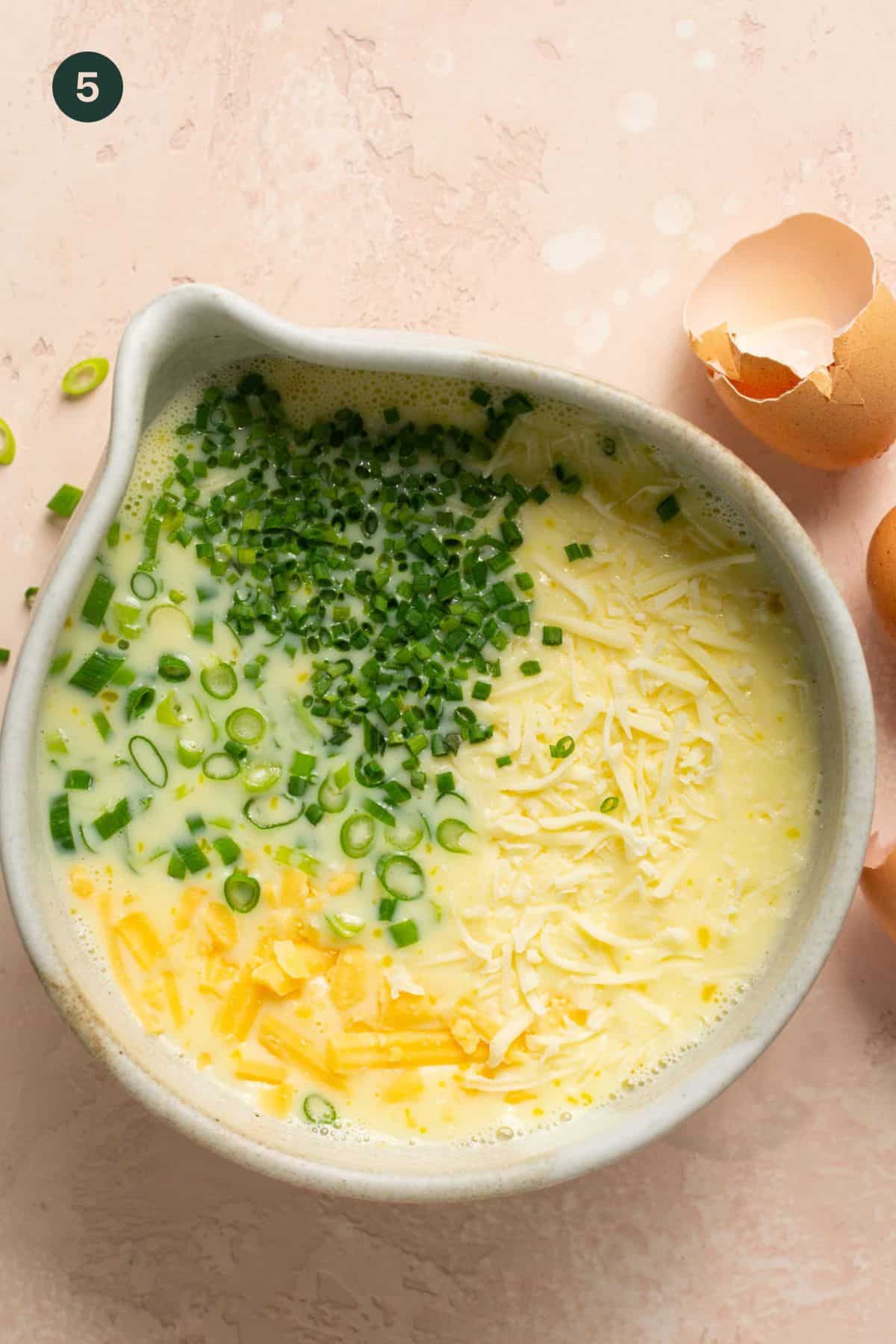 Chives, cheese and green onions added to egg and milk mixture.
