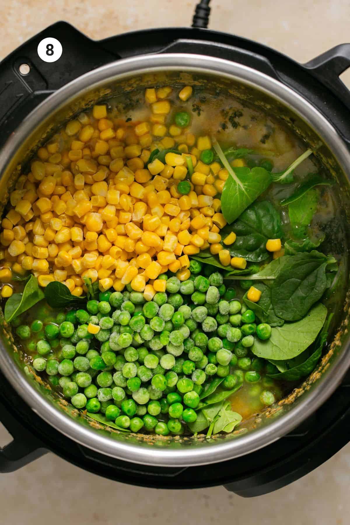 Corn, peas and spinach added to the pot. 