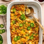 Fully baked chicken and waffle casserole with maple syrup and jalapenos on top.