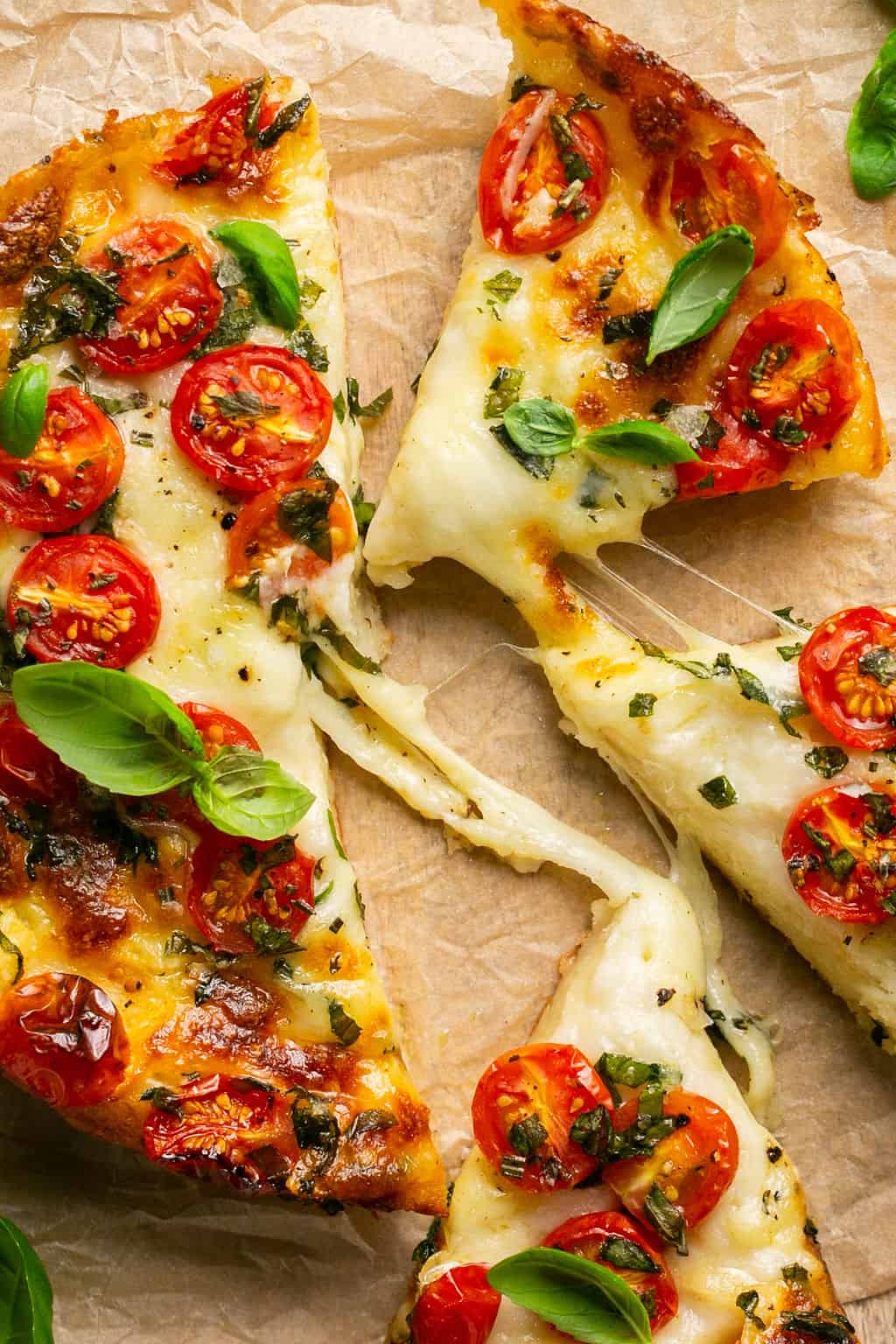 Slices of caprese focaccia attached with melted cheese.