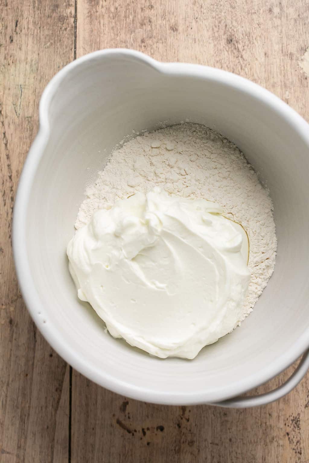 Flour and yogurt in a white bowl.