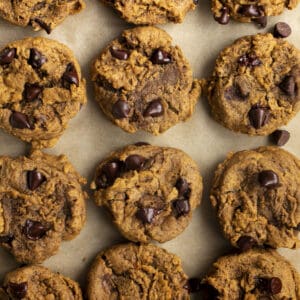 Cookies with chocolate chips on a sheet pan.