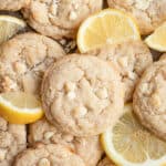 Pile of lemon white chocolate cookies and lemon slices.