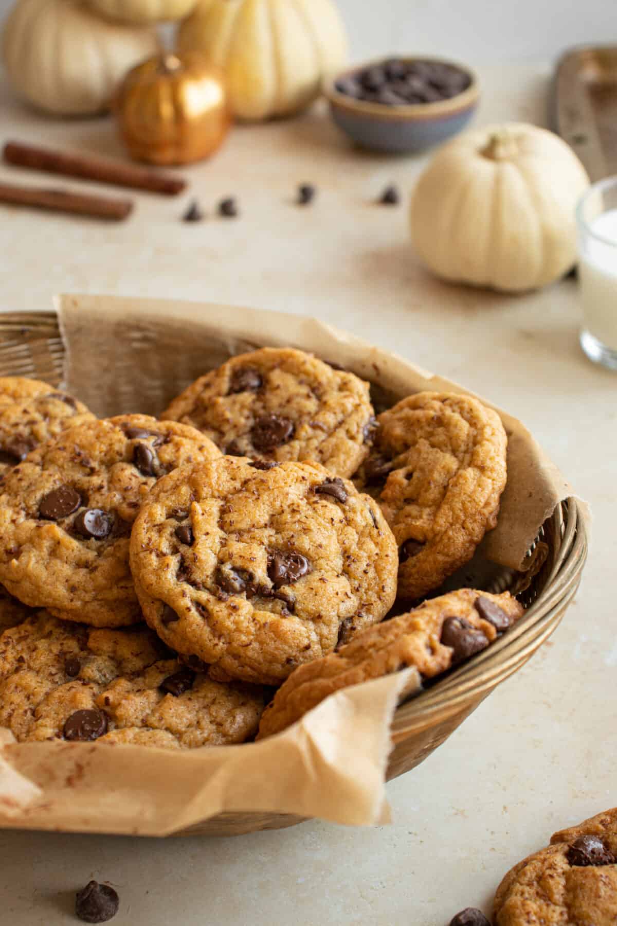 Cookies in a bowl with pumpkins in the background. 