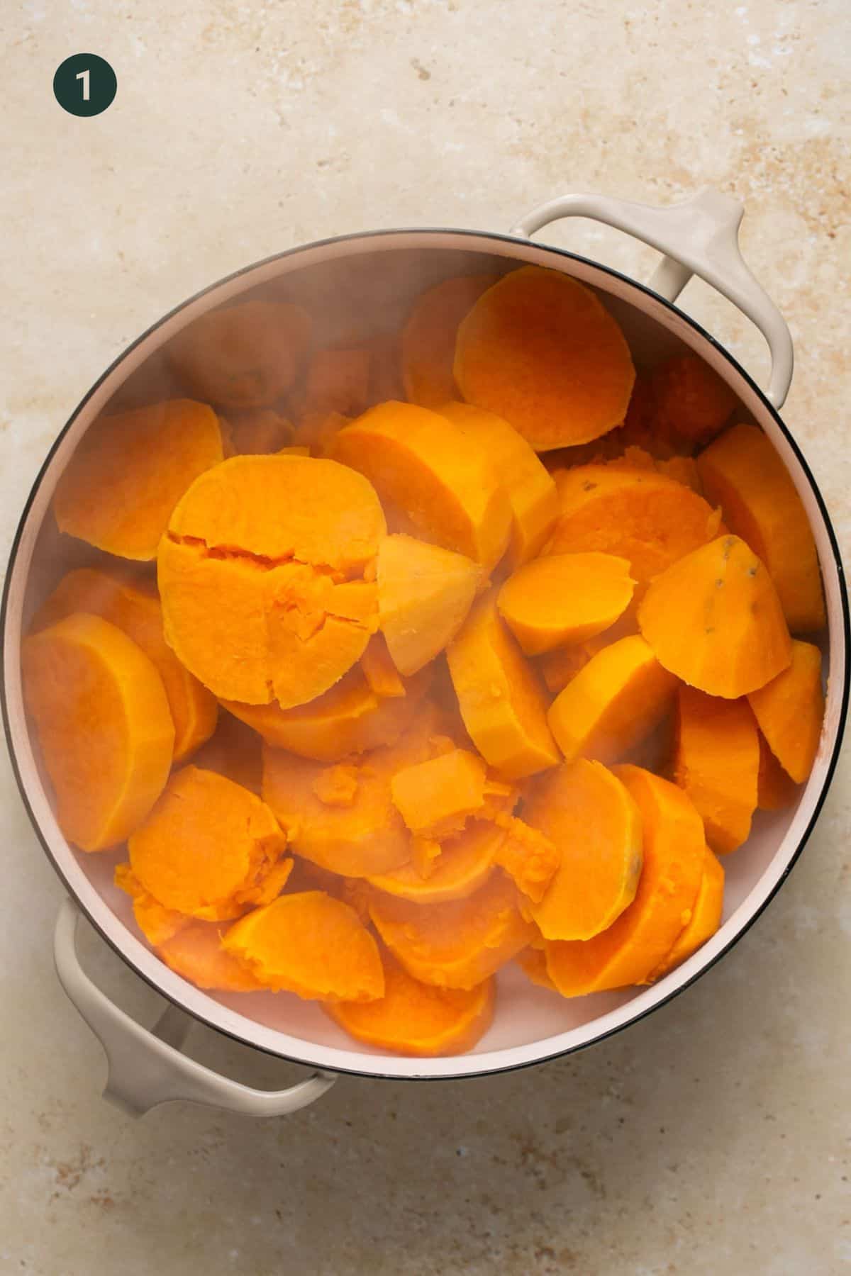 Hot, freshly-steamed, sliced sweet potatoes in a pot. 