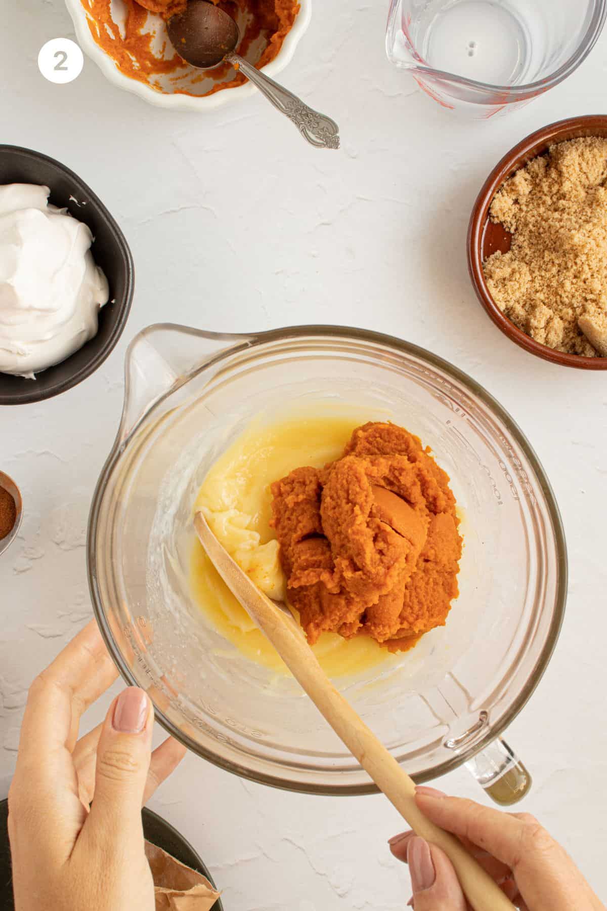 Pumpkin puree added to pudding mixture in a bowl.