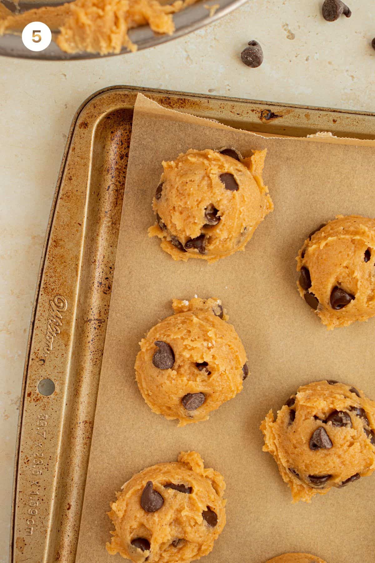 Cookie dough scooped onto baking sheet. 