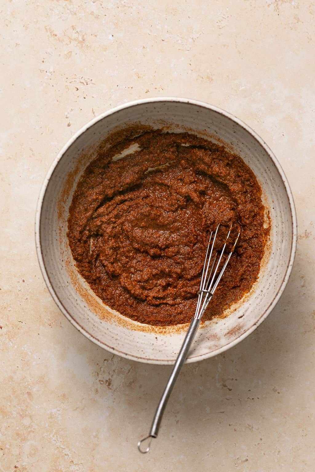 Seasoning mixed with water to create a paste in a bowl.