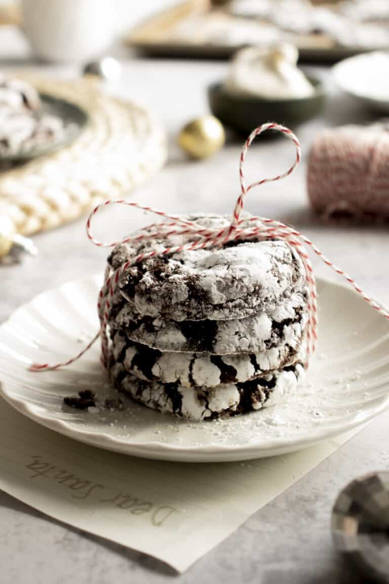 Stacked chocolate cookies tied with a bow and a letter to Santa under the plate they're sitting on.