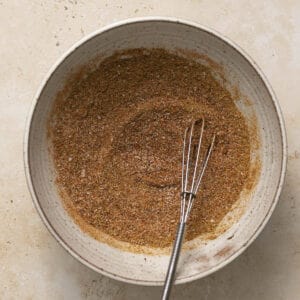 Taco seasoning fully mixed in a small bowl with whisk.