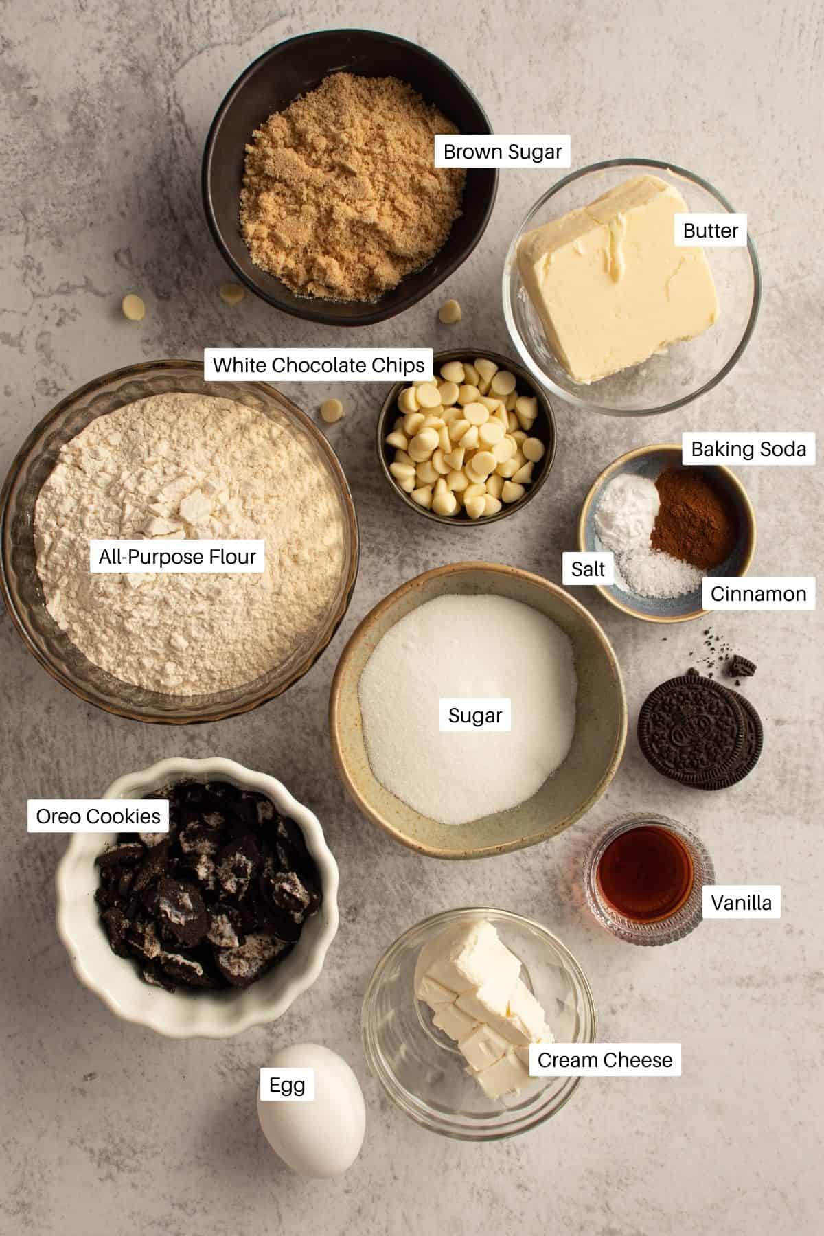 Ingredients for cookies laid out including flour, Oreos, and cinnamon.