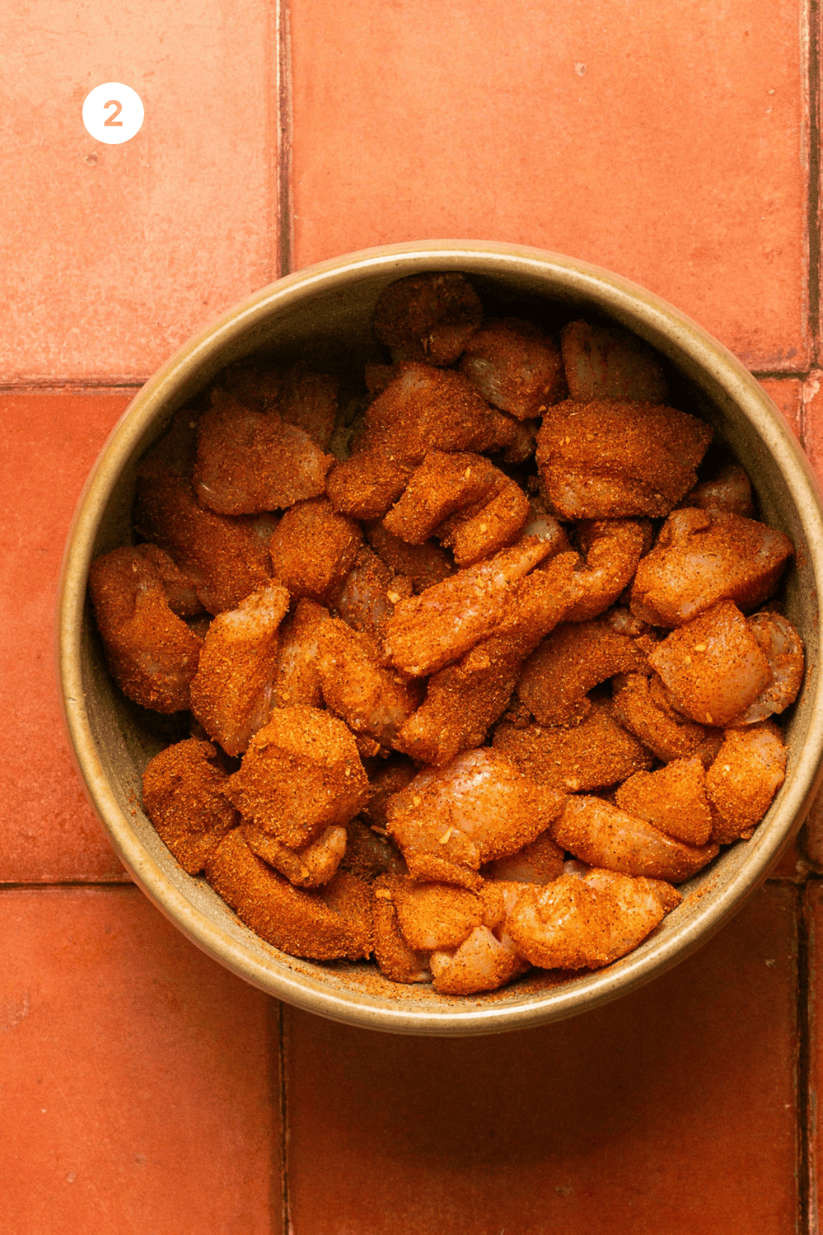 Seasoned chicken in a bowl.