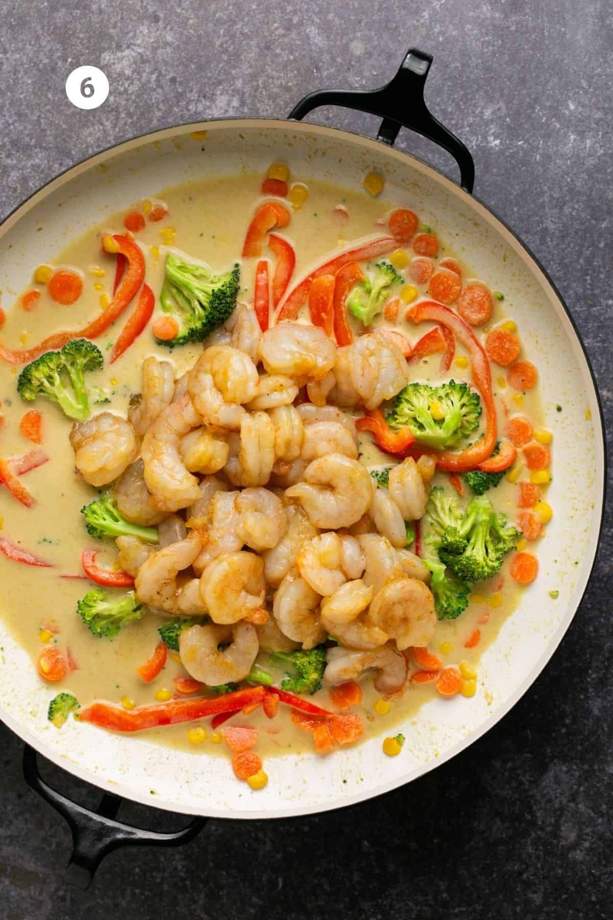 Shrimp added to the pan with vegetables. 