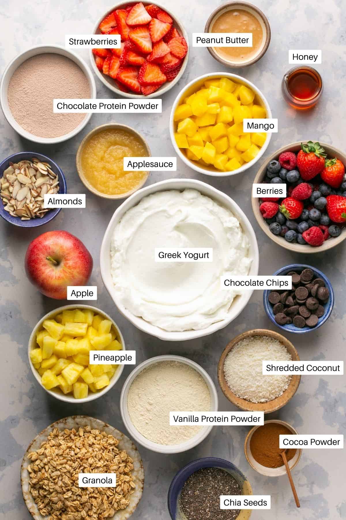 Greek yogurt, berries, peanut butter, protein powders and toppings for all four yogurt bowl types. 