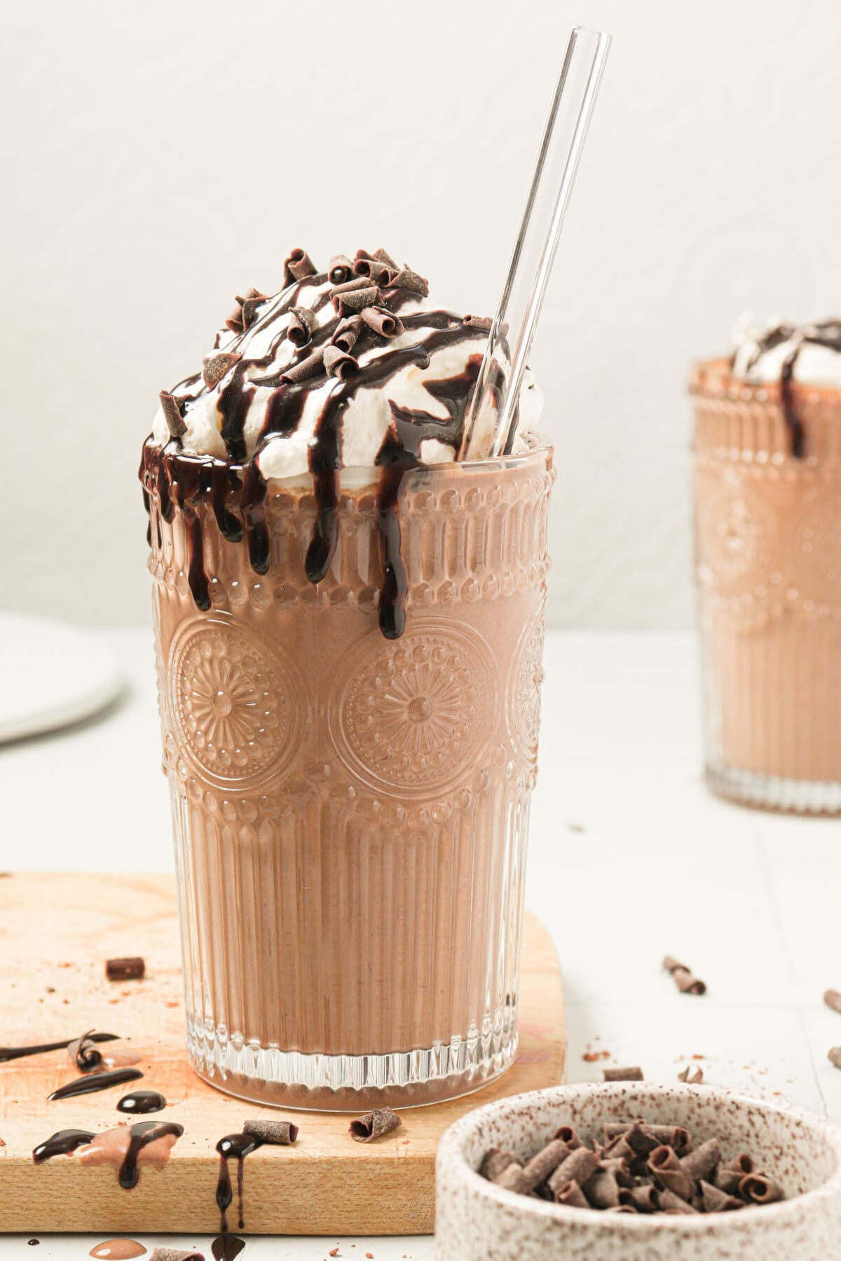 Chocolate smoothie topped with whipped cream, chocolate syrup and shaved chocolate. 