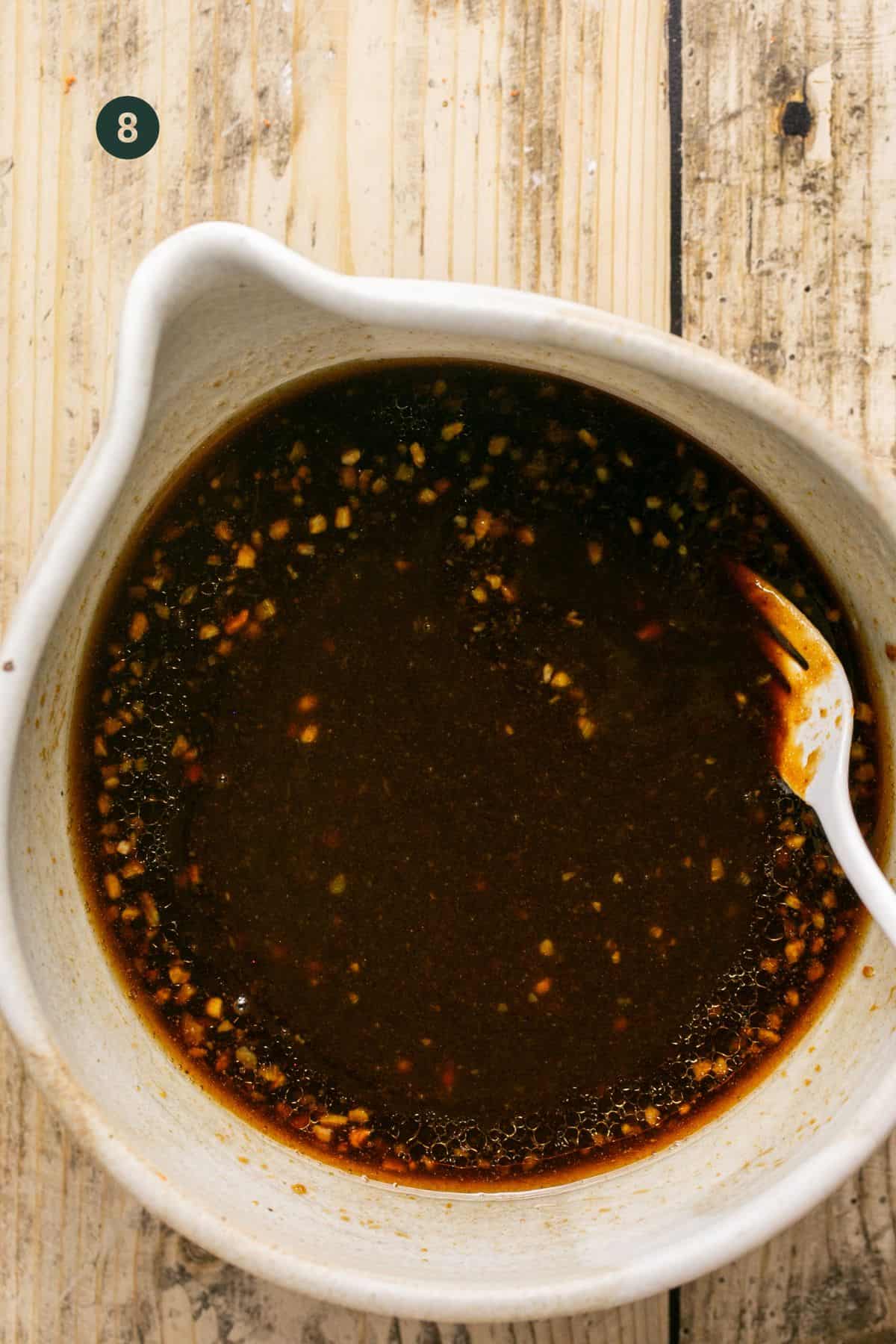 Sweet and savory sauce ingredients mixed in a small mixing bowl. 