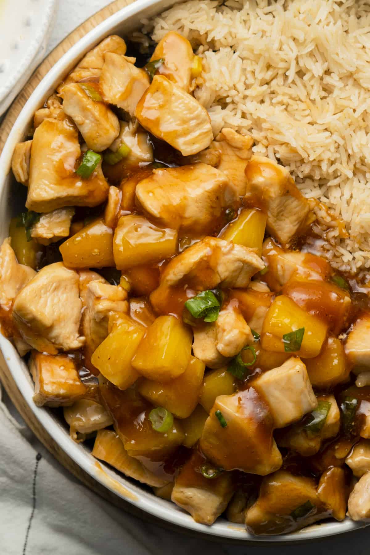 Sweet and sour chicken without breading in a bowl with rice and pineapple. 
