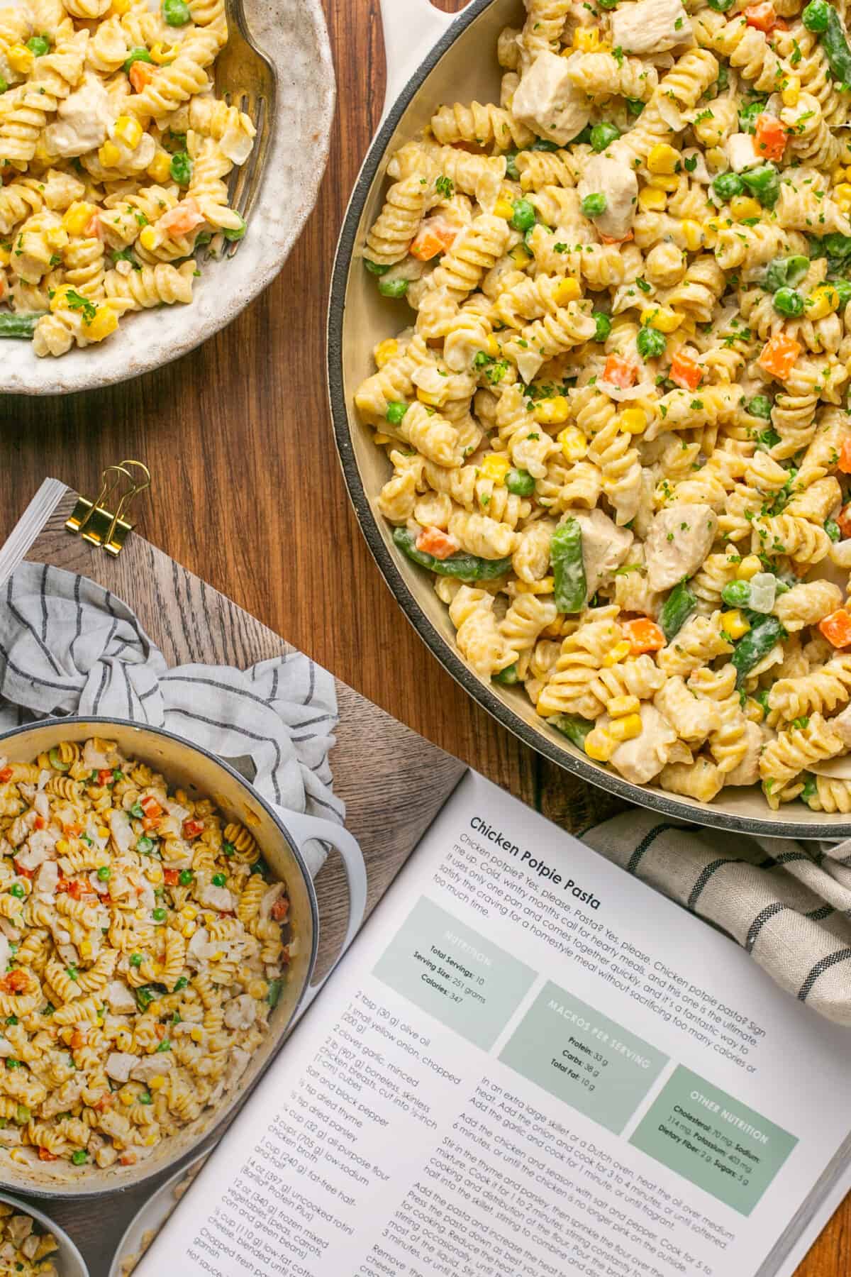 Chicken pot pie pasta in a large bowl with the cookbook next to it open to the recipe.
