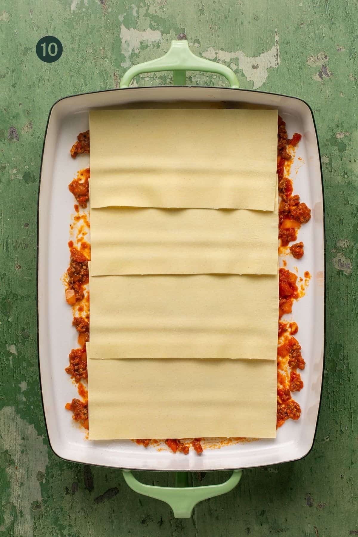 Four oven ready lasagna noodles layer along the bottom of the dish. 