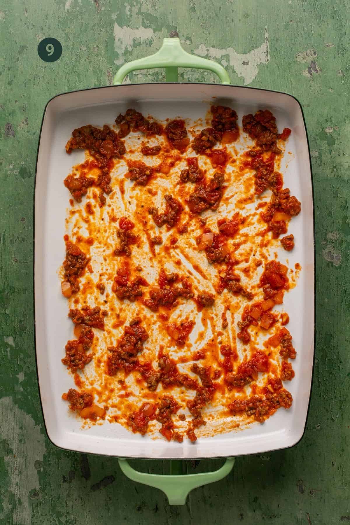 Dollop of sauce added to a 9x13 inch baking dish and spread around the bottom. 
