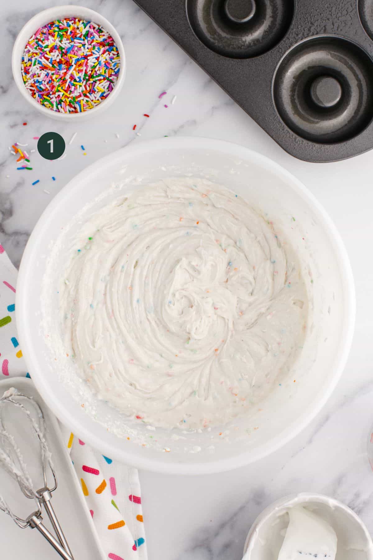 Donut batter completely mixed in a bowl.